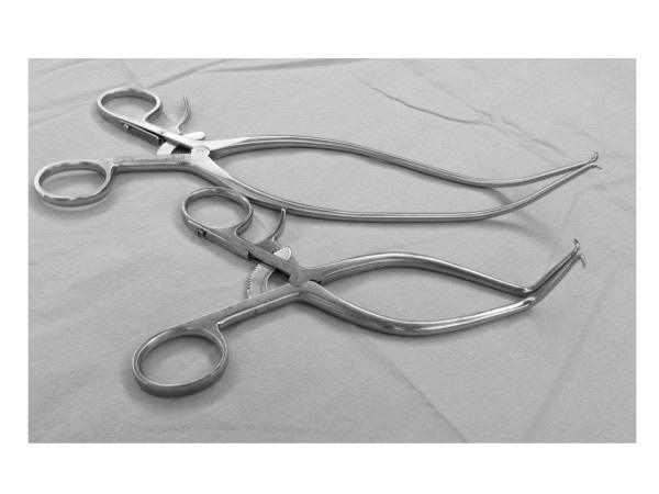 Two Gelpi self-retaining retractors with hinged arms and single curved pointed tips